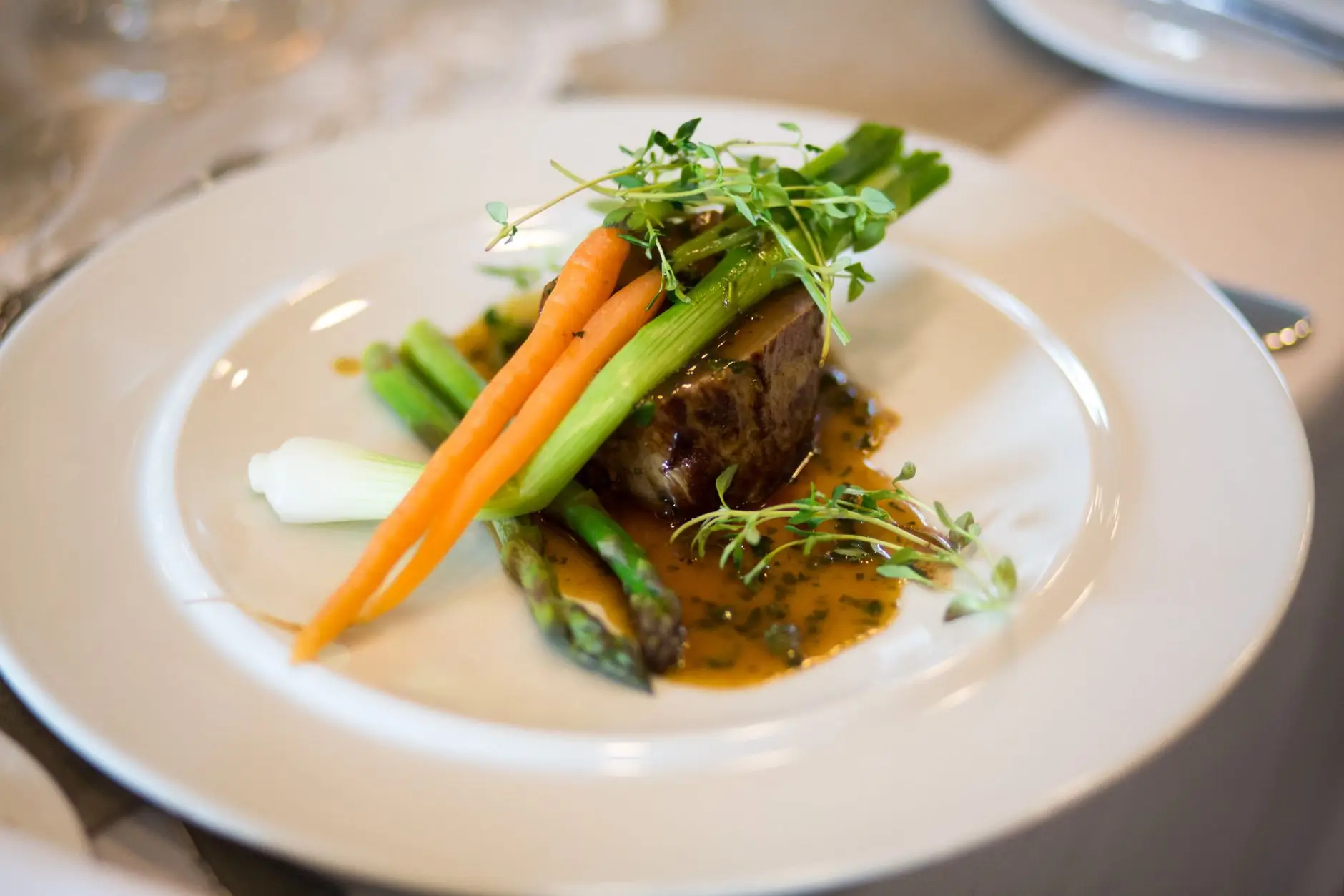 Chef plating an Ontario-inspired dish at Nexoragrand Stay